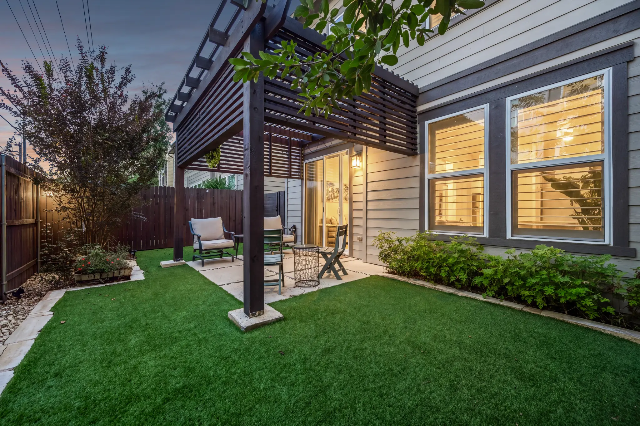 Twilight courtyard with pergola at 13805 Zink Bend